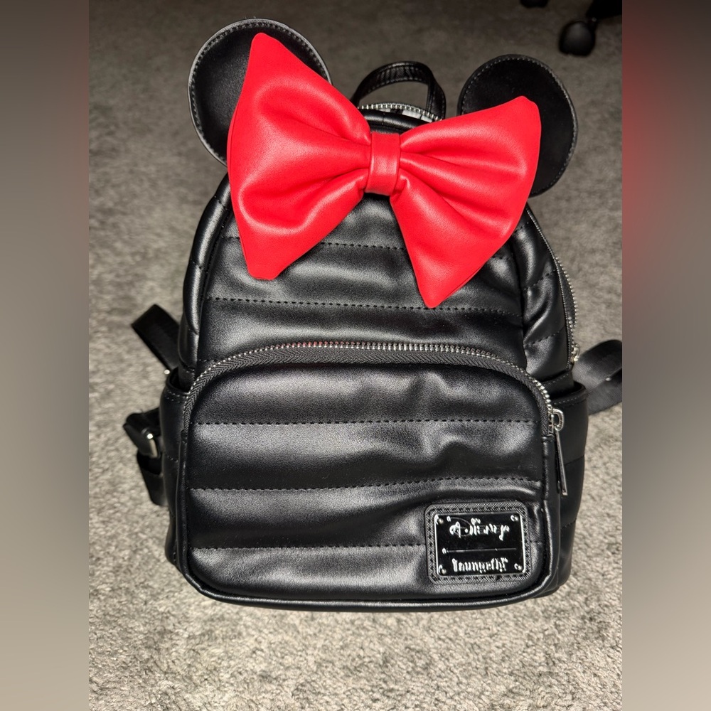 Black Minnie loungefly backpack with red Minnie Mouse Bow. Perfect condition